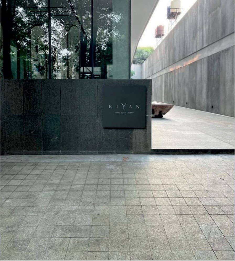 The entrance, behind a wall of dark stone.