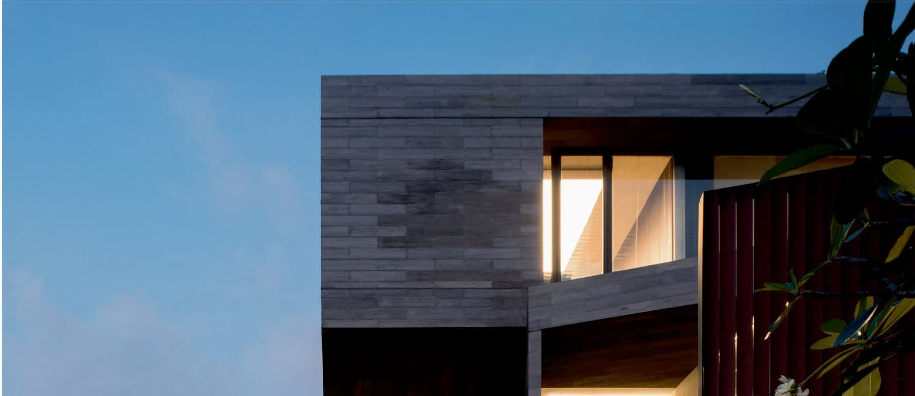 MENSA, Semarang — stacked stone volumes above a glazed dining floor and a reflecting pool.